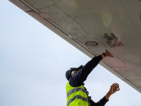 Ground handler performing aircraft visual check