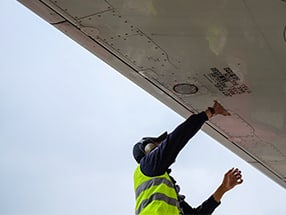 Ground-handler-performing-aircraft-visual-check